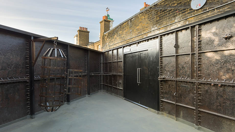 Outside gallery in the courtyard of the CCA gallery featuring a sculpture of an open cage