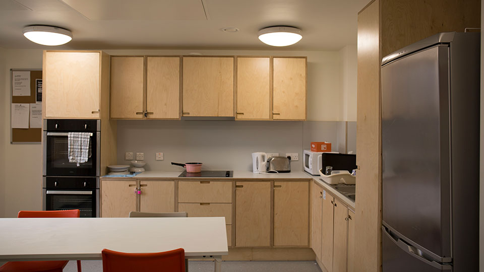 A kitchen space with lots of storage inside Surrey House