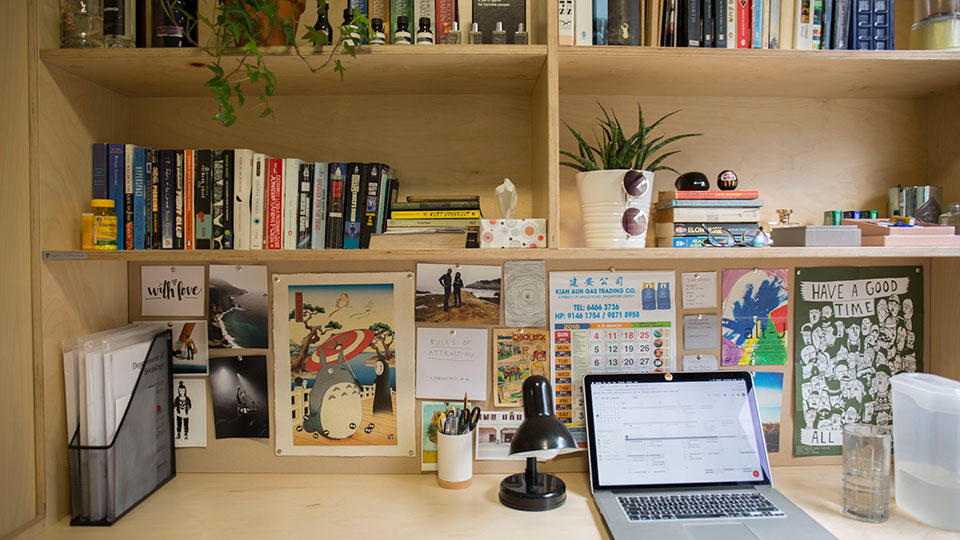 Desk space with books, plants and a laptop in Raymont Hall